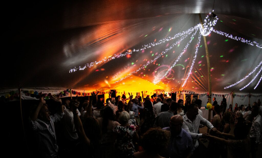 people dancing under black and white canopy